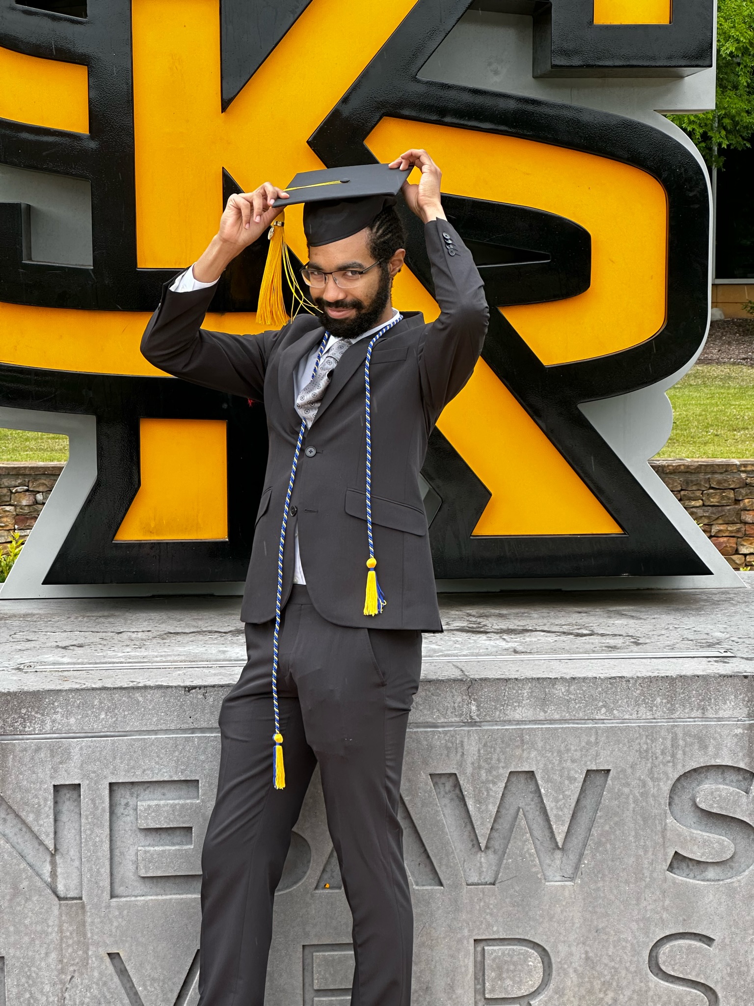 Milo in a suit and graduation cap